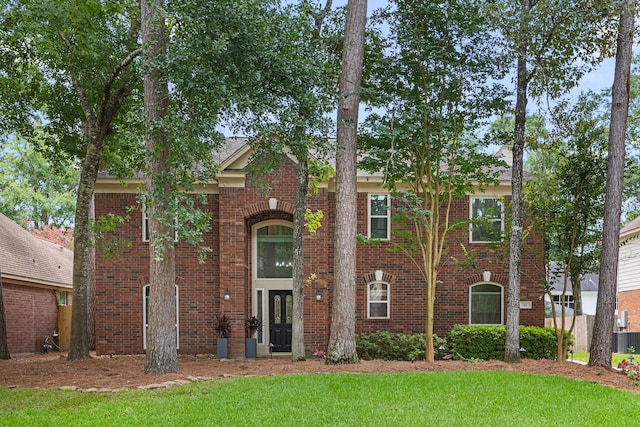 22 Windfern Pl, The Woodlands, TX 77382 - view of front of house featuring brick siding and a front lawn