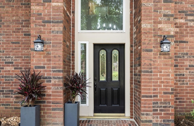 22 Windfern Pl, The Woodlands, TX 77382 - doorway to property featuring brick siding
