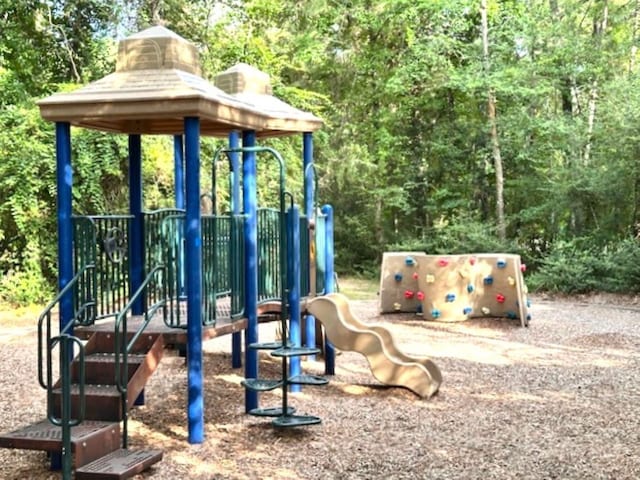 22 Windfern Pl, The Woodlands, TX 77382 - community jungle gym with a wooded view