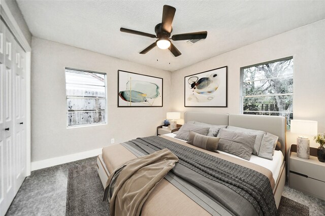 5817 Beechnut St, Houston, TX 77074 - bedroom with carpet flooring, a closet, multiple windows, and a ceiling fan