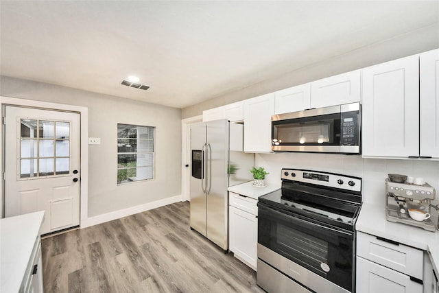 5817 Beechnut St, Houston, TX 77074 - kitchen with appliances with stainless steel finishes, light countertops, and white cabinetry