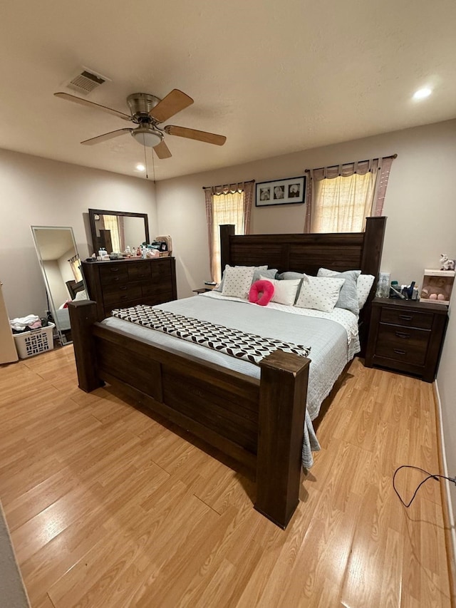 7431 Water Park Ln, Houston, TX 77086 - bedroom featuring light wood-style floors, multiple windows, recessed lighting, and ceiling fan