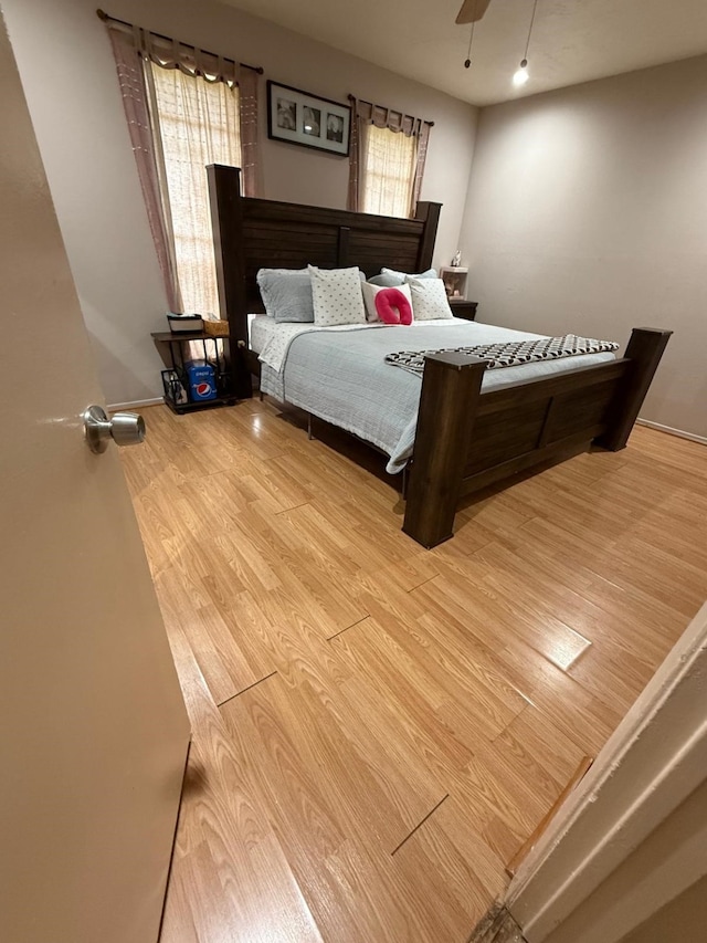 7431 Water Park Ln, Houston, TX 77086 - bedroom with wood finished floors, multiple windows, and ceiling fan