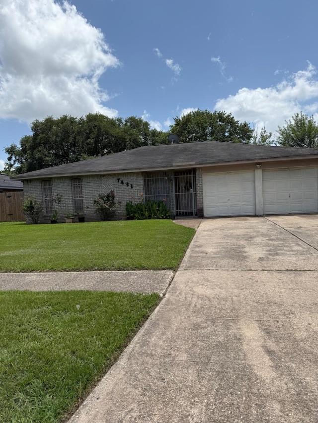 7431 Water Park Ln, Houston, TX 77086 - ranch-style house with concrete driveway, a front yard, an attached garage, and brick siding