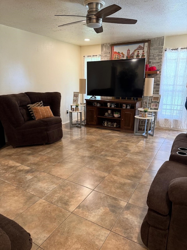 7431 Water Park Ln, Houston, TX 77086 - tiled living room with a ceiling fan and a textured ceiling