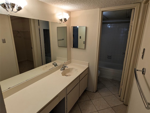 2120 El Paseo St Unit 2607, Houston, TX 77054 - full bath featuring vanity, tile patterned flooring, a textured ceiling, a walk in closet, and shower / washtub combination