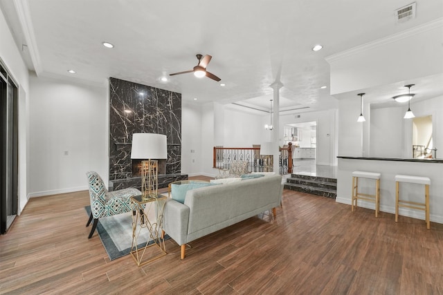12013 Naughton St, Houston, TX 77024 - living area featuring a ceiling fan, recessed lighting, wood finished floors, a premium fireplace, and crown molding