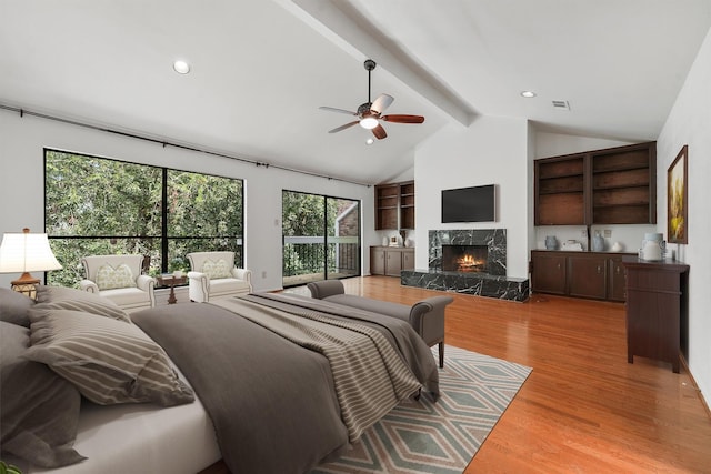 12013 Naughton St, Houston, TX 77024 - bedroom with beamed ceiling, wood finished floors, a high end fireplace, high vaulted ceiling, and ceiling fan