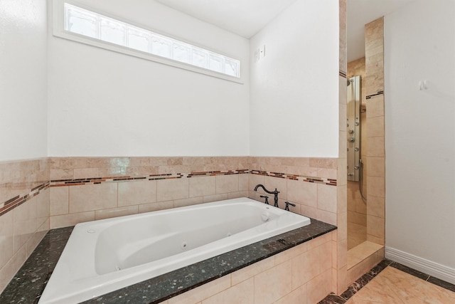 12013 Naughton St, Houston, TX 77024 - bathroom featuring a tub with jets and a tile shower