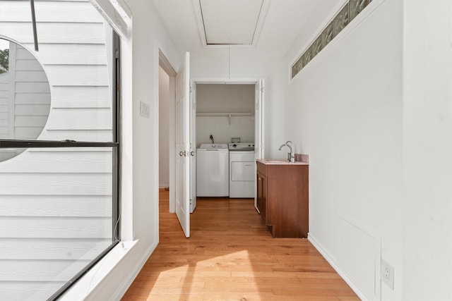 12013 Naughton St, Houston, TX 77024 - corridor with attic access, washing machine and dryer, and light wood finished floors