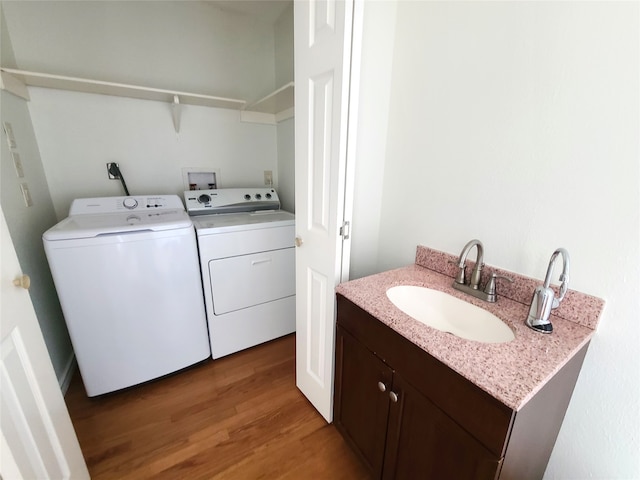 12013 Naughton St, Houston, TX 77024 - laundry room with independent washer and dryer and light wood-style flooring
