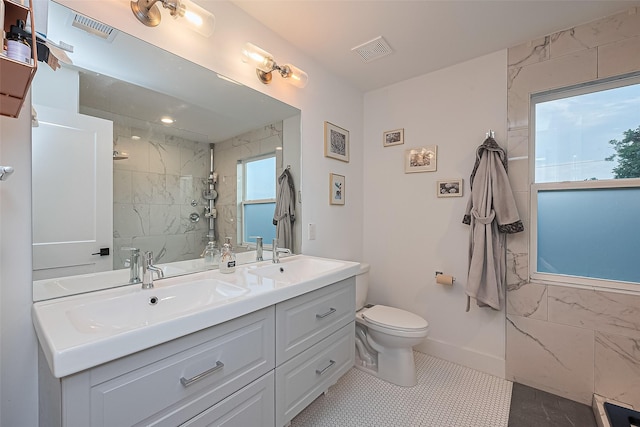 209 Blueberry St, Houston, TX 77018 - bathroom with double vanity, a tile shower, and tile patterned floors