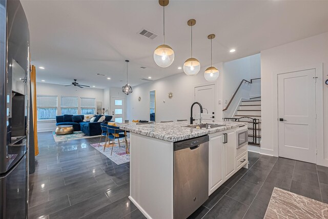 209 Blueberry St, Houston, TX 77018 - kitchen featuring dishwasher, ceiling fan, white cabinetry, light stone countertops, and open floor plan