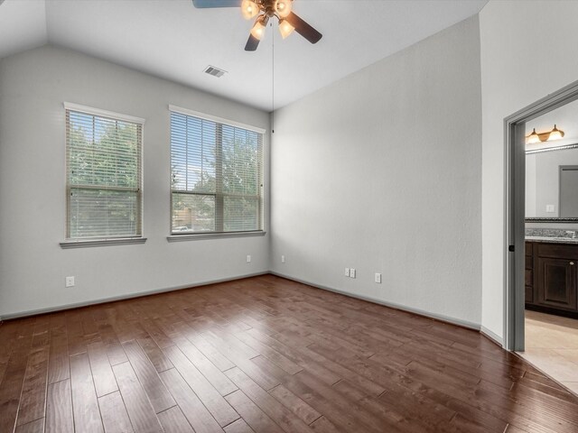 211 Cheswood Forest Pl, Montgomery, TX 77316 - spare room featuring ceiling fan, wood finished floors, and vaulted ceiling