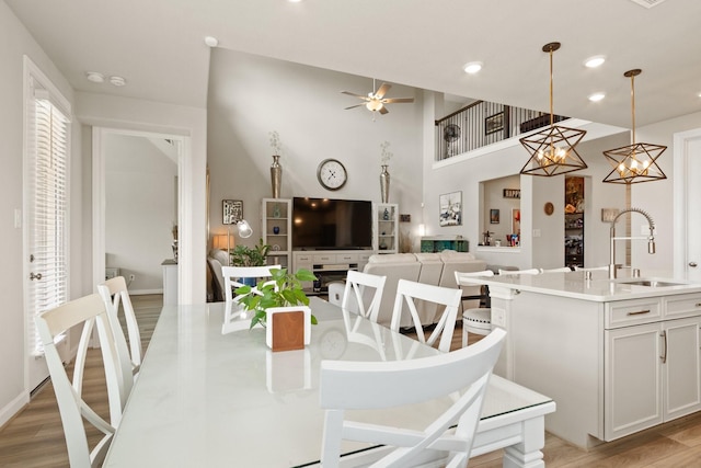 503 Highland Thicket Dr, Conroe, TX 77316 - dining room featuring light wood-style flooring, a ceiling fan, recessed lighting, and a high ceiling