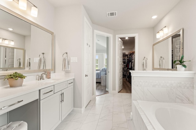 503 Highland Thicket Dr, Conroe, TX 77316 - ensuite bathroom featuring marble finish flooring, vanity, a bath, recessed lighting, and a spacious closet