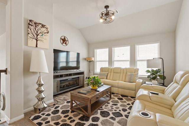 503 Highland Thicket Dr, Conroe, TX 77316 - living area with vaulted ceiling, healthy amount of natural light, and wood finished floors