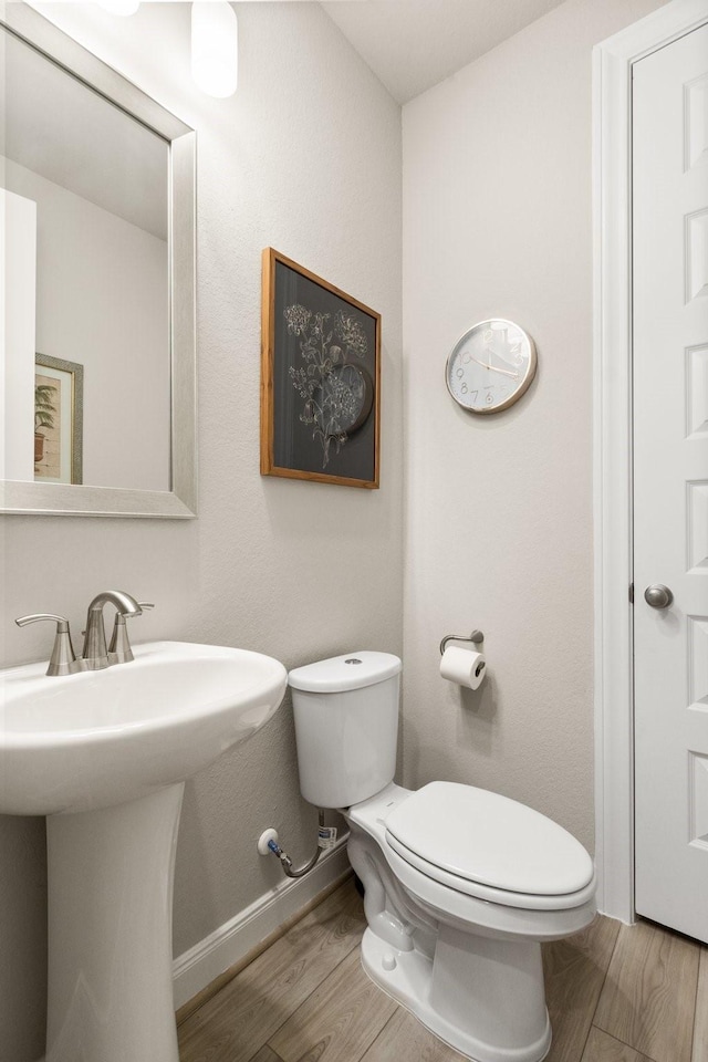 503 Highland Thicket Dr, Conroe, TX 77316 - half bathroom with toilet and wood finished floors