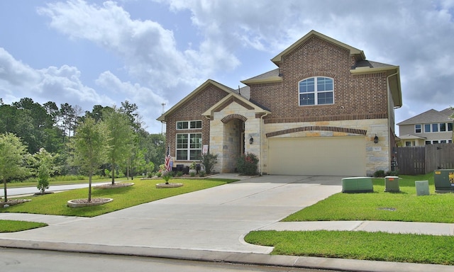 503 Highland Thicket Dr, Conroe, TX 77316 - view of front facade with stone siding, driveway, an attached garage, and brick siding