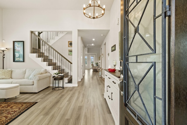 503 Highland Thicket Dr, Conroe, TX 77316 - entryway with stairs, a chandelier, light wood-type flooring, and a high ceiling