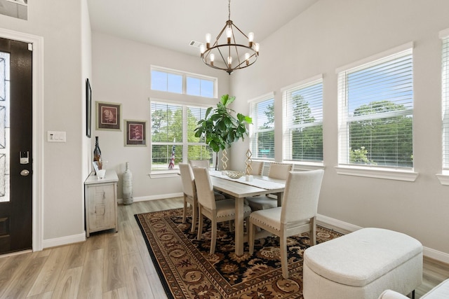 503 Highland Thicket Dr, Conroe, TX 77316 - dining space with a chandelier, light wood-style floors, and a towering ceiling