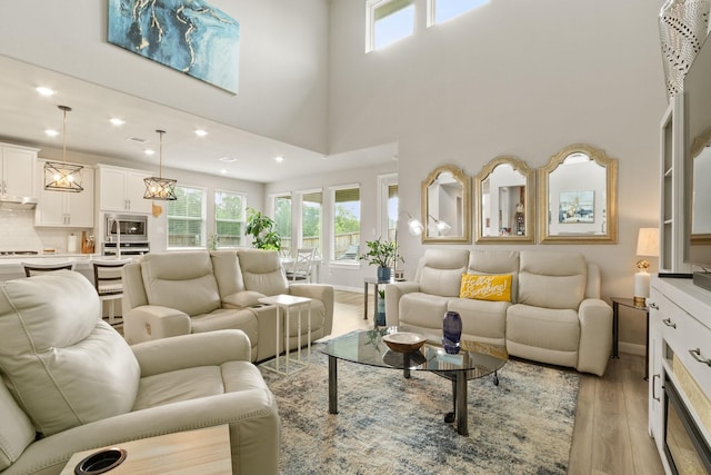 503 Highland Thicket Dr, Conroe, TX 77316 - living area with healthy amount of natural light, light wood-type flooring, recessed lighting, and a high ceiling