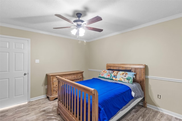 169 April Cv, Conroe, TX 77356 - bedroom featuring light wood-style flooring, ornamental molding, a ceiling fan, and a textured ceiling