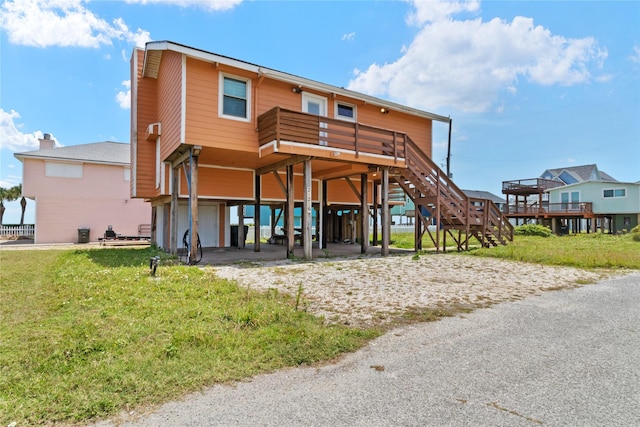 21216 Gulf Dr, Galveston, TX 77554 - rear view of house featuring a garage, a carport, stairway, and a wooden deck
