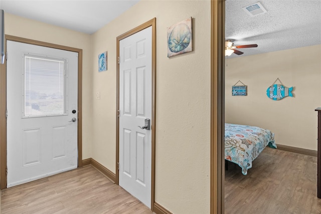 21216 Gulf Dr, Galveston, TX 77554 - entrance foyer with light wood-style floors and ceiling fan