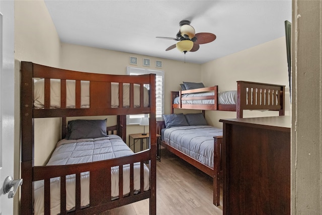 21216 Gulf Dr, Galveston, TX 77554 - bedroom with wood finished floors and a ceiling fan
