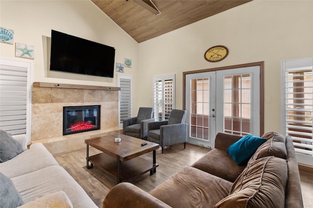 21216 Gulf Dr, Galveston, TX 77554 - living area featuring high vaulted ceiling, wood finished floors, wood ceiling, a premium fireplace, and french doors