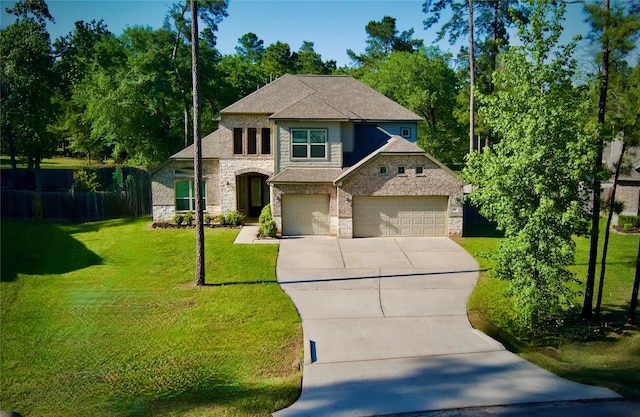 59 Beaconsfield Dr, Magnolia, TX 77355 - view of front of home featuring stone siding, driveway, a garage, and a front yard