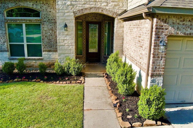 59 Beaconsfield Dr, Magnolia, TX 77355 - view of exterior entry with an attached garage, brick siding, a lawn, and stone siding