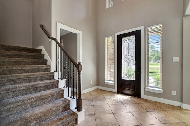 59 Beaconsfield Dr, Magnolia, TX 77355 - foyer featuring healthy amount of natural light, stairs, tile patterned floors, and a high ceiling