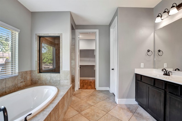 59 Beaconsfield Dr, Magnolia, TX 77355 - full bath with a bath, vanity, a walk in closet, and tile patterned flooring
