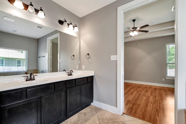 59 Beaconsfield Dr, Magnolia, TX 77355 - full bath with healthy amount of natural light, double vanity, a ceiling fan, and wood finished floors