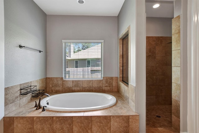 59 Beaconsfield Dr, Magnolia, TX 77355 - full bathroom featuring a garden tub and tiled shower