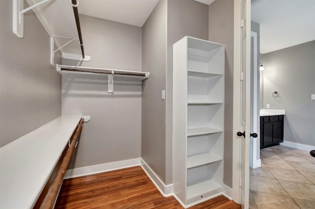 59 Beaconsfield Dr, Magnolia, TX 77355 - walk in closet with wood finished floors