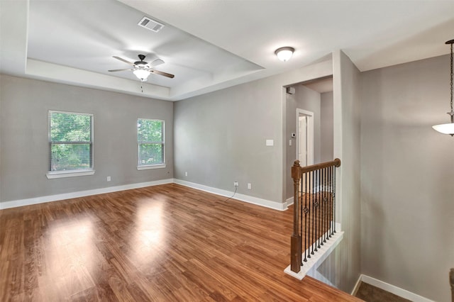 59 Beaconsfield Dr, Magnolia, TX 77355 - unfurnished room with a tray ceiling, a ceiling fan, and wood finished floors