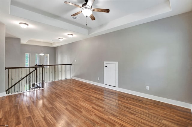 59 Beaconsfield Dr, Magnolia, TX 77355 - spare room featuring a tray ceiling, ceiling fan, and wood finished floors
