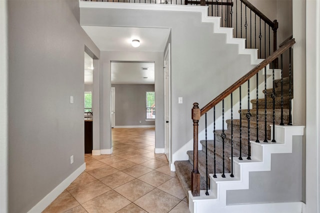 59 Beaconsfield Dr, Magnolia, TX 77355 - stairway with baseboards and tile patterned flooring