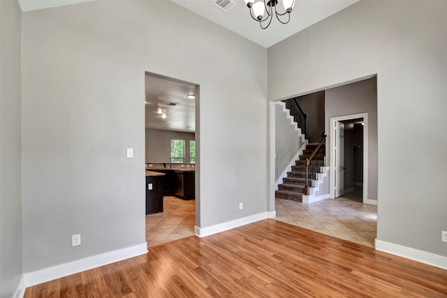 59 Beaconsfield Dr, Magnolia, TX 77355 - foyer entrance featuring stairs, a chandelier, light wood finished floors, and a towering ceiling