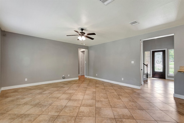 59 Beaconsfield Dr, Magnolia, TX 77355 - empty room featuring a ceiling fan, light tile patterned flooring, and stairway