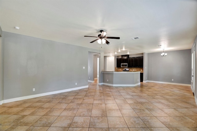 59 Beaconsfield Dr, Magnolia, TX 77355 - unfurnished living room with a chandelier, ceiling fan, and light tile patterned floors