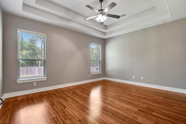 59 Beaconsfield Dr, Magnolia, TX 77355 - spare room featuring a raised ceiling, plenty of natural light, wood finished floors, and ceiling fan