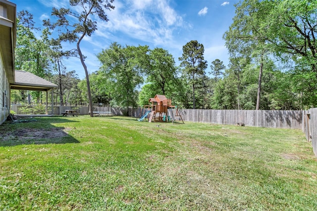 59 Beaconsfield Dr, Magnolia, TX 77355 - fenced backyard featuring a playground