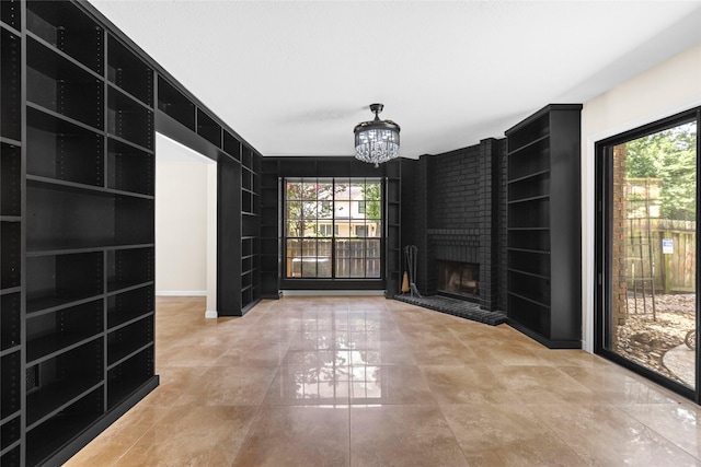 5 Cat Feet Ct, Spring, TX 77381 - unfurnished living room with built in features, plenty of natural light, a chandelier, and a fireplace