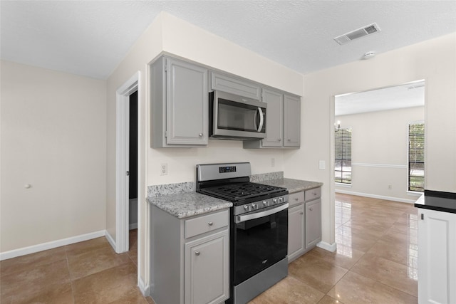 5 Cat Feet Ct, Spring, TX 77381 - kitchen with appliances with stainless steel finishes, gray cabinets, and light tile patterned floors