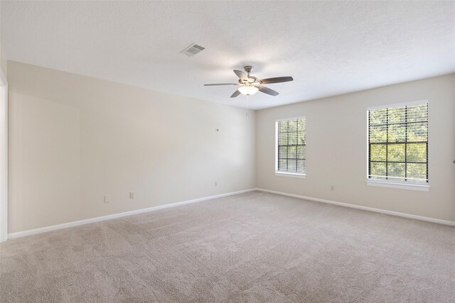 5 Cat Feet Ct, Spring, TX 77381 - empty room with light colored carpet, a ceiling fan, and a textured ceiling