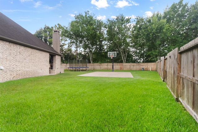 100 Anderson Ranch Ln, Friendswood, TX 77546 - fenced backyard featuring a trampoline and a patio
